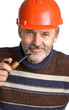smiling men in a red building helmet