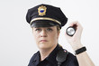Portrait of a police woman holding a flashlight.