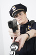 Police woman pointing handgun and holding flashlight.