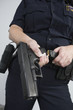 Foto: Police woman loading a pistol. Police woman loading a pistol.