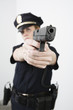 Photo: View of a police woman aiming with pistol. View of a police woman aiming with pistol.