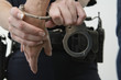 Close up of a person being hand cuffed.