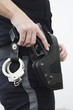 Police woman removing gun from the holster.