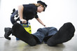 Police woman administering first aid to a person.