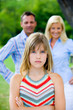 Foto: Portrait of a girl with Parents in the background Portrait of a girl with Parents in the background