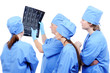 group of  surgeons in uniform looking at X-ray