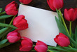 White envelope surrounded by tulips
