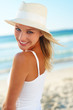 Portrait of a cute young couple with a straw hat at the beach Portrait of a cute young couple with a straw hat at the beach