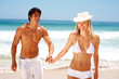 Attractive young couple having fun at the beach