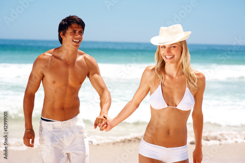 Photo: Attractive young couple having fun at the beach Attractive young couple having fun at the beach