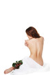 beautiful girl with flowers touches a body