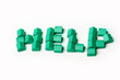 Model plastic houses/homes forming the word HELP.