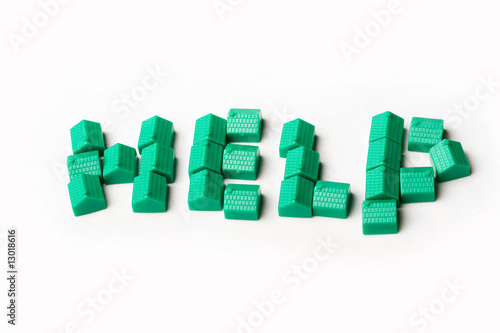 Photo: Model plastic houses/homes forming the word HELP. Model plastic houses/homes forming the word HELP.