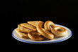 Barankas and cookies on white plate with blue border.