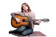 portrait of young woman with guitar over white