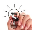 Female hand drawing a light bulb