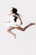 Foto: Young athletic female in dress jumping Young athletic female in dress jumping
