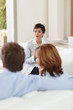A financial planner speaking to a couple at home A financial planner speaking to a couple at home