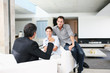 Young couple at home is discussion with a real estate agent