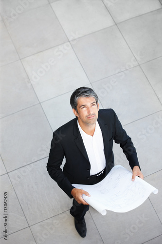 Photo: A successful business man looking upwards A successful business man looking upwards
