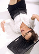 Happy businesswoman with notebook rolling on the floor