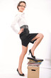 Young businesswoman standing on pile of documents