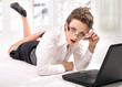 Young businesswoman with laptop looking attentively