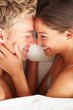 Overhead view of young intimate couple having fun in bed