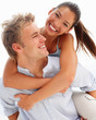 Lovely couple smiling over a white background - piggyback