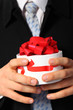 Businessman with gift box in hands