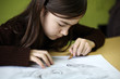 Girl drawing using pencil