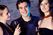 Two young women and man with champagne glasses Two young women and man with champagne glasses