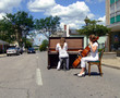 Playing the piano and cello in the street with traffic
