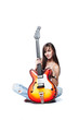 Attractive young female holding a guitar isolated on white Attractive young female holding a guitar isolated on white