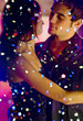 Young happy dancing amorous couple at celebration