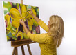 female artist painting dendrobium orchids on canvas