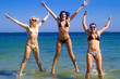 Girls jumping in the sea