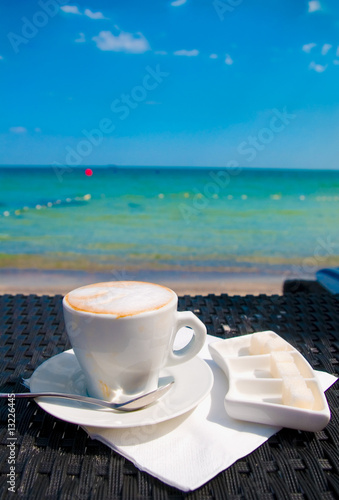 Photo: Cup of coffee at the beach Cup of coffee at the beach