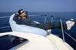 Man on bow boat relaxed on bean bag