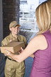 Photo: Delivery courier delivering package Delivery courier delivering package