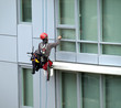 Window washer rappelling in a residential building Window washer rappelling in a residential building