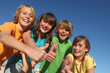 group of happy tweens at summer camp thumbs up