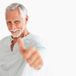 Photo: Portrait of a happy old man showing a thumbs up on white Portrait of a happy old man showing a thumbs up on white