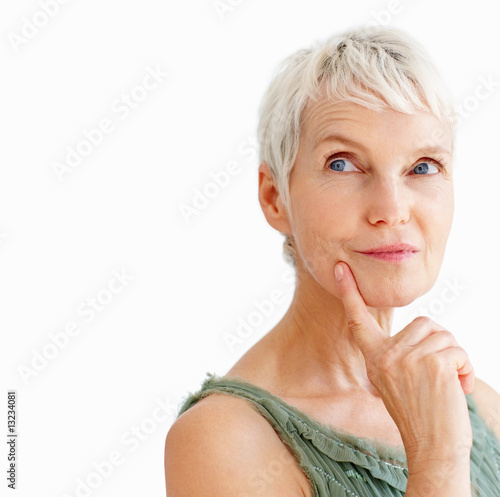 Foto: A beautiful senior female in a contemplative with finger on her A beautiful senior female in a contemplative with finger on her