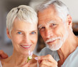 Photo: Closeup of a senior couple playing with a flower Closeup of a senior couple playing with a flower