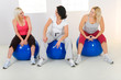 Elder women sitting on fitness balls