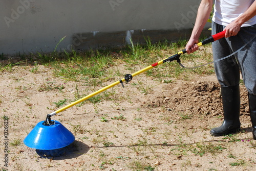 Young Farmer Fertilizing the Soil with Sulphate