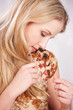 Young blond woman checking her hair