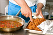 Chef hands with frying pan on professional kitchen
