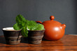 Asian teapot with sprigs of mint for tea Asian teapot with sprigs of mint for tea